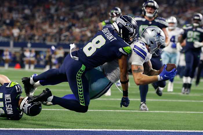 Dallas Cowboys tight end Peyton Hendershot (49) scores a touchdown against Seattle Seahawks cornerback Coby Bryant (8) in the fourth quarter at AT&T Stadium.